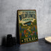 A vintage-style metal sign for the Lady Bird Johnson Wildflower Center in Texas, featuring a colorful illustration of a garden with flowers and a building.