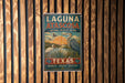 A vintage-style metal sign for the Laguna Atascosa National Wildlife Refuge in Texas, featuring a bird illustration and text promoting the refuge's wildlife, habitat, and heritage.