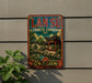 A vintage-style metal sign for the Lan Su Chinese Garden in Oregon, featuring a traditional Chinese temple and landscape.
