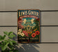 A metal sign for the Lewis Ginter Botanical Garden in Richmond, Virginia, featuring a colorful illustration of the greenhouse and flowers.