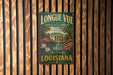 A vintage-style metal sign for "Longe Vue House and Gardens" in New Orleans, Louisiana, featuring a tropical garden scene with a house and palm trees.