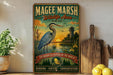 A vintage-style metal sign for the Magee Marsh Wildlife Area in Ohio, featuring a blue heron and a sunset landscape.