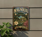 A vintage-style sign for Magnolia Plantation and Gardens in South Carolina, featuring a lush garden scene with a large white magnolia flower and pink azalea blooms.
