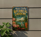 A vintage-style metal sign for "Marie Selby Botanical Gardens" in Florida, featuring a tropical landscape with palm trees, flowers, and a bird.