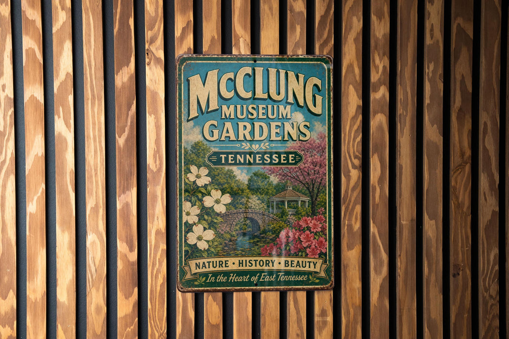 A vintage-style metal sign for the McCling Museum Gardens in Tennessee, featuring a garden scene with flowers and a gazebo.