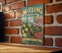 A vintage-style metal sign for the McCling Museum Gardens in Tennessee, featuring a scenic illustration of a garden with a gazebo and flowers.