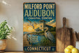 a vintage-style sign for Milford Point Audubon, a coastal center in Connecticut, with a scenic illustration of a coastal landscape and birds.