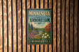 A vintage-style metal sign for the Minnesota Landscape Arboretum, featuring a scenic landscape with trees, flowers, and a lake.