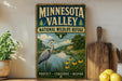 A vintage-style sign for the Minnesota Valley National Wildlife Refuge, featuring an illustration of a heron and a scenic landscape.