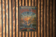 A vintage metal sign for the Sandhill Crane National Wildlife Refuge in Mississippi, featuring an illustration of two sandhill cranes standing in a pond with a sunset in the background.
