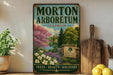 A vintage-style metal sign for the Morton Arboretum in Illinois, featuring a scenic landscape with trees, flowers, and a pond.