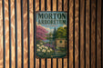 A vintage metal sign for Morton Arboretum in Illinois, featuring a scenic landscape with trees, flowers, and a pond.