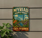 A vintage-style metal sign for the Myriad Botanical Gardens in Oklahoma, featuring a colorful illustration of the gardens and a city skyline.