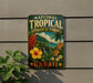 A vintage-style metal sign for the National Tropical Botanical Garden in Hawaii, featuring colorful tropical flowers and plants.
