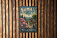 A vintage metal sign for the Naunkeag Garden in Massachusetts, featuring a scenic landscape with a building and trees.