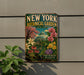 A vintage-style metal sign for the New York Botanical Garden, featuring a colorful illustration of various plants and flowers.