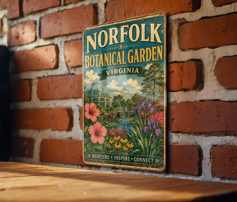 A vintage-style metal sign for the Norfolk Botanical Garden in Virginia, featuring a lush garden scene with flowers, plants, and a greenhouse.