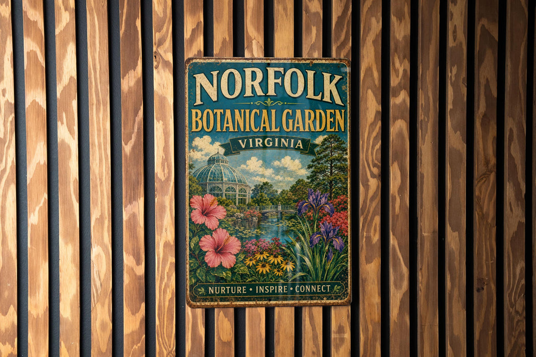 A vintage-style metal sign for the Norfolk Botanical Garden in Virginia, featuring a lush garden scene with flowers, plants, and a greenhouse.