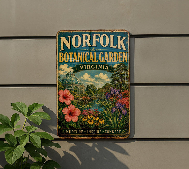 A vintage-style metal sign for the Norfolk Botanical Garden in Virginia, featuring a colorful illustration of a garden with flowers and a greenhouse.