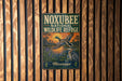 A vintage metal sign for the Noxubee National Wildlife Refuge in Mississippi, featuring an illustration of a bird in flight over a pond with a sunset in the background.