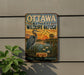 A vintage metal sign for the Ottawa National Wildlife Refuge, featuring an illustration of a crane and a sunset landscape.
