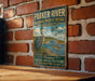 A vintage-style metal sign for the Parker River National Wildlife Refuge in Massachusetts, featuring an illustration of a heron and ducks in a grassy area with a river.