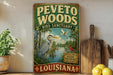 A vintage-style sign for the Peeta Woods Bird Sanctuary in Louisiana, featuring an illustration of a heron and other wildlife in a lush, natural setting.