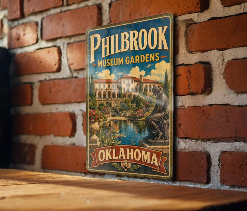 A vintage-style metal sign for Philbrook Museum Gardens in Oklahoma, featuring a scenic illustration of a garden with a statue and a building in the background.