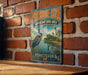 A vintage-style metal sign for Presque Isle, Pennsylvania, featuring an illustration of a crane and a lighthouse, mounted on a brick wall.