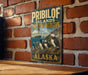 A vintage metal sign for the Pribilof Islands, Alaska, featuring illustrations of puffins and the text "PRIBILOF ISLANDS SEABird Colony ALASKA".