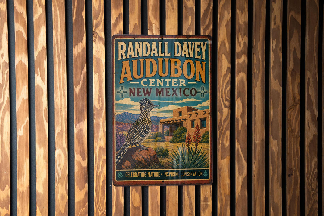 A vintage metal sign for Randall Davey Audubon Center in New Mexico, featuring a bird and desert landscape.
