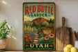 a vintage-style sign for the Red Butte Garden in Utah, with a scenic mountain landscape and colorful flowers.