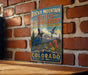 A vintage-style metal sign for Rocky Mountain Bird Observatory in Colorado, featuring a blue bird and a mountain landscape.
