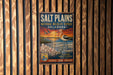 A vintage metal sign for the Salt Plains National Wildlife Refuge in Oklahoma, featuring an illustration of a bird and a sunset landscape.