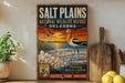 A vintage-style metal sign for the Salt Plains National Wildlife Refuge in Oklahoma, featuring an illustration of a bird and a sunset over a body of water.