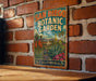 A vintage metal sign for the San Diego Botanic Garden in California, featuring a colorful illustration of the garden's flora and fauna.
