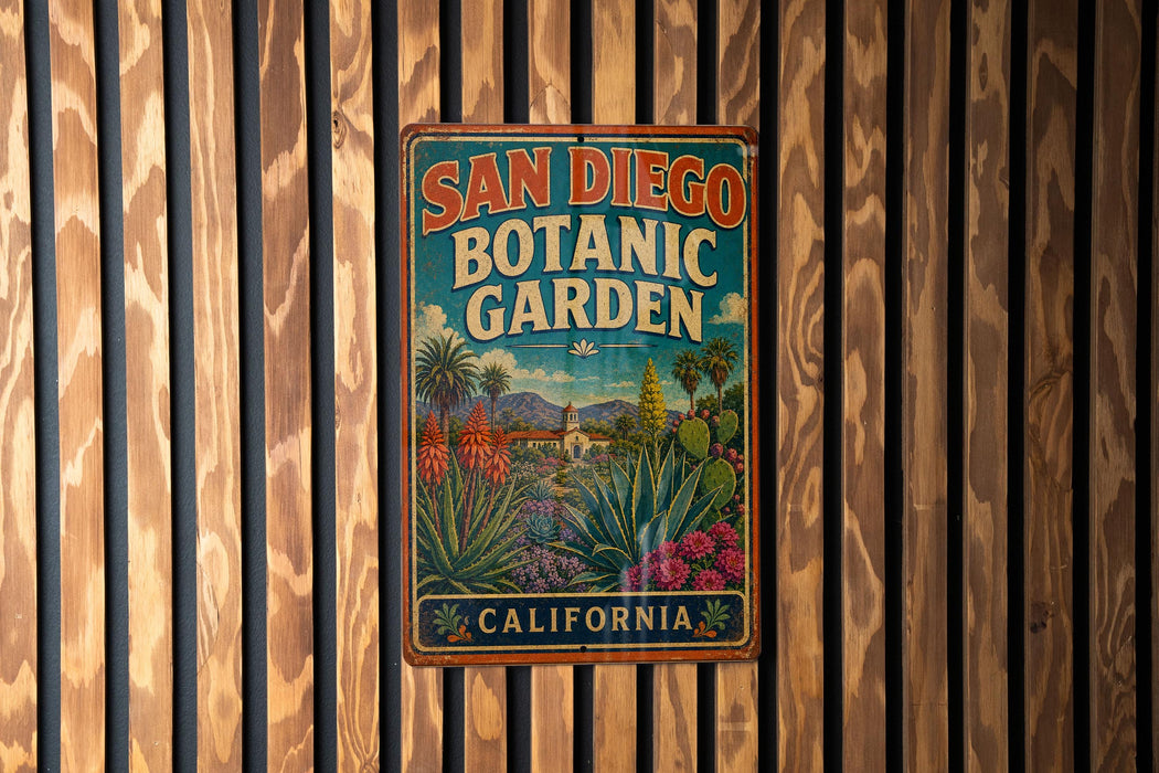A vintage-style metal sign for the San Diego Botanic Garden in California, featuring a colorful illustration of various plants and a tropical landscape.