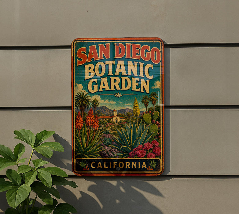 A vintage-style metal sign for the San Diego Botanic Garden, featuring a colorful illustration of various plants and flowers.