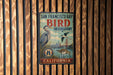 A vintage-style metal sign for San Francisco Bay Bird Observatory in California, featuring illustrations of birds and the Golden Gate Bridge.