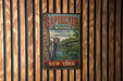 A vintage metal sign with the text "SAPSUCKER WOODS CORNELL LAB ORNITHOLOGY" and "Discover NATURE INSPIRE CONSERVE" is displayed on a wooden wall.
