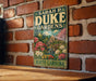 A vintage-style metal sign for "Sara P. Duke Gardens" in North Carolina, featuring a garden scene with flowers and a building.