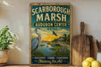 A vintage-style sign for the Audubon Center in Maine, featuring an illustration of a heron and a sunset over a lake.