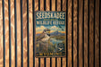 A vintage-style metal sign for the Seedskadee National Wildlife Refuge in Wyoming, featuring a bird perched on a tree stump against a scenic landscape.