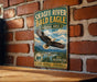 A vintage-style sign for the Skagit River Bald Eagle Natural Area in Washington, featuring an eagle in flight and a scenic landscape.