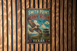 A vintage metal sign for Smith Point Hawk Watch in Texas, featuring an illustration of a hawk in flight and a lookout tower.