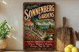 A vintage-style sign for Sonnenberg Gardens in Canandaigua, New York, featuring a scenic image of the gardens with a gazebo and a lake in the background.
