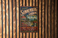 A vintage-style metal sign for Sonnenberg Gardens in Canandaigua Lake, New York, featuring a scenic illustration of the gardens and a red-roofed gazebo.