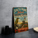 A vintage-style sign for the South Padre Island Birding Center, featuring a bird illustration and text promoting birdwatching and conservation.