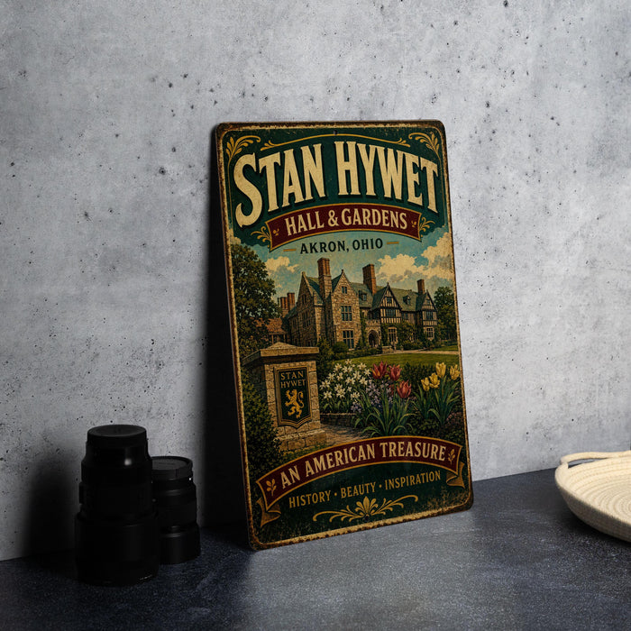 A vintage-style sign for "Stan Hy Wet" Hall & Gardens in Akron, Ohio, featuring an illustration of a historic building surrounded by a well-maintained garden.