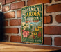 A vintage-style metal sign for the State Botanical Garden of Georgia, featuring a garden scene with flowers and a greenhouse.